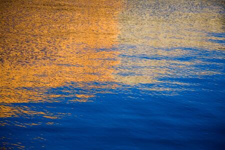 Reflection from houses on quay in the riverの写真素材