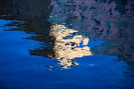 Reflection in the river of the house on quay