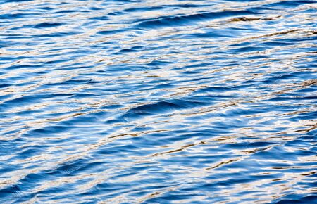 Blue water with reflections in the riverの写真素材