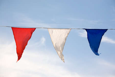 red, white, blue flags and the skyの写真素材