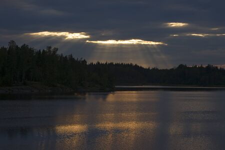 forest lake and the sunlight through the clouds