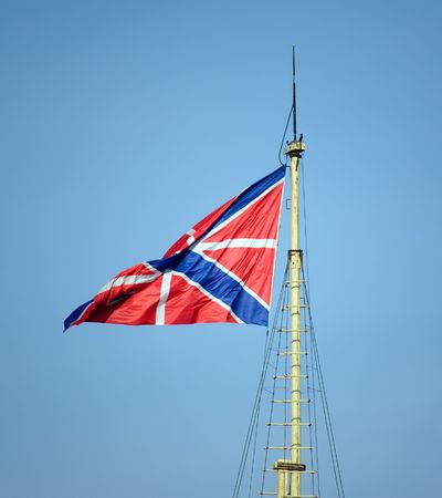 waving flag of Russian navy in front of blue skyの写真素材