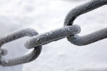 Parts of a chain, covered by hoarfrost on a frostの写真素材