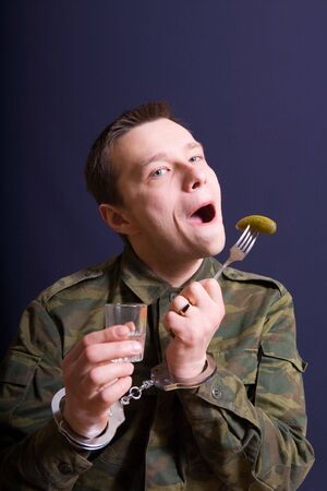 The man drinking vodka with the held down handsの写真素材