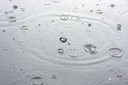 Drops of a rain in water close upの写真素材