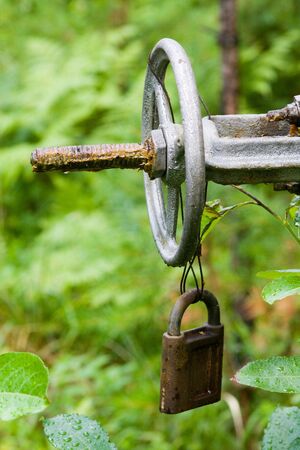 The old lock on a pipe with the tapの写真素材