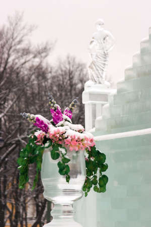 Flowers in a vase about an ice palace with sculpturesの写真素材
