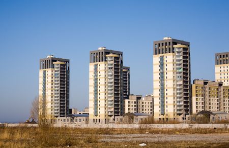 City spring landscape with three identical high houses