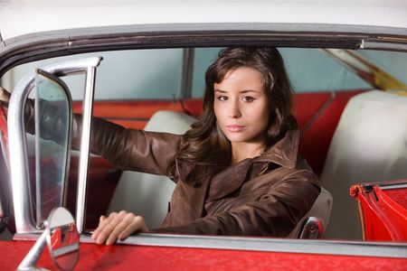 The beautiful girl at the wheel the retrocar