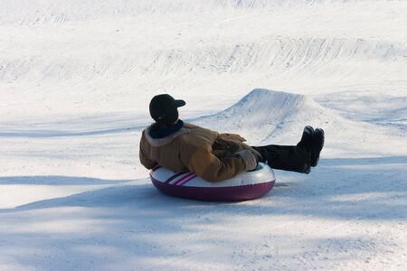 The girl drives down from a hill on tireの写真素材