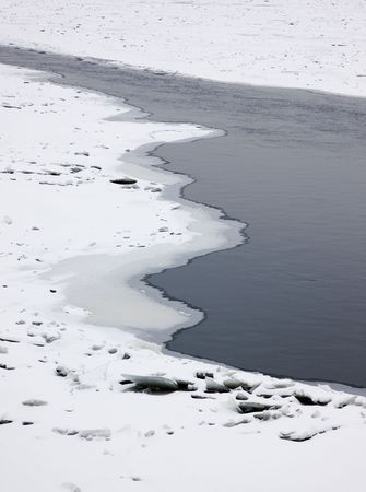 Not frozen stream in the middle of the river in the winterの写真素材
