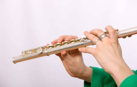 Hands of the girl playing a fluteの写真素材