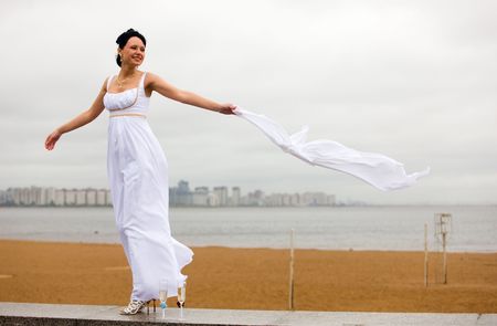 The bride in a wedding-day on the bank of a gulfの写真素材