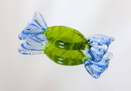 Glass sweet and its reflection on a mirrorの写真素材