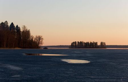 Quiet sunset on wood lake in springの写真素材