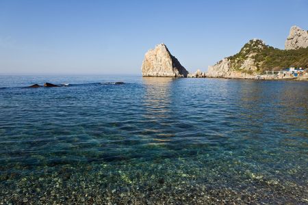 Sea landscape with a rock in sunny dayの写真素材