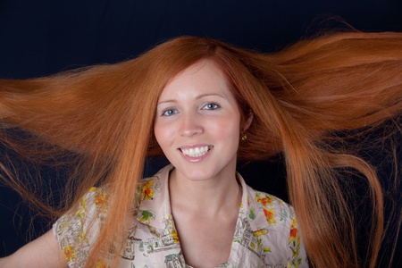 Portrait of the girl with long red hair
