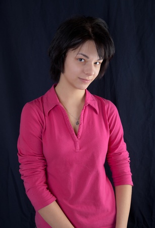 Portrait of the beautiful girl against a dark backgroundの写真素材