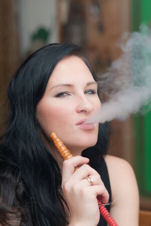 Portrait of the girl smoking a hookah