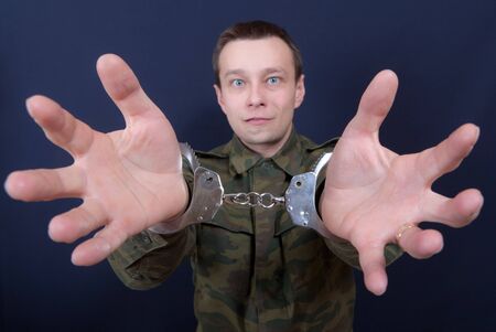 Portrait of the man with handcuffs on hands