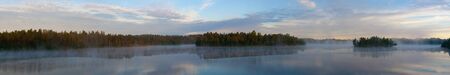 Morning fog over wood lake, a panorama
