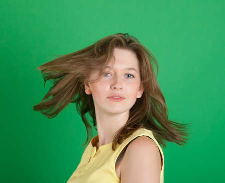 Portrait of the beautiful girl on a green backgroundの写真素材