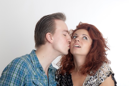 The man kisses the girl on a cheekの写真素材