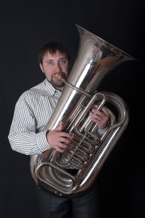 Portrait of the man playing a tuba