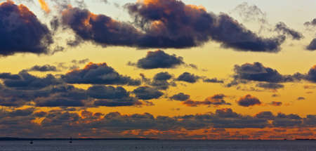 Sunset over the sea with clouds, panoramaの写真素材