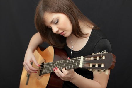 portrait of the girl playing on a guitar