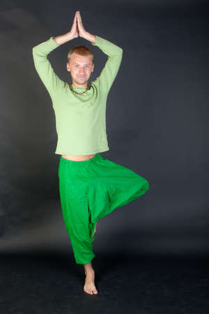 the man in the green. Yoga pose vrikshasanaの写真素材