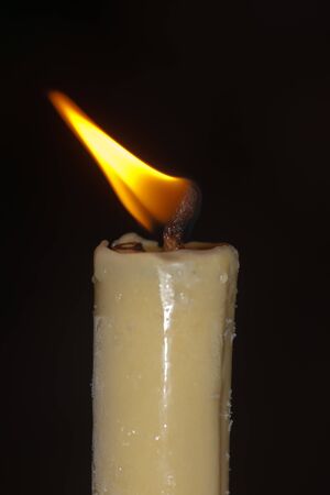 burning candle close up against a dark backgroundの写真素材