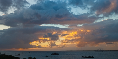 bright decline over the sea, the industrial ships in the gulfの写真素材