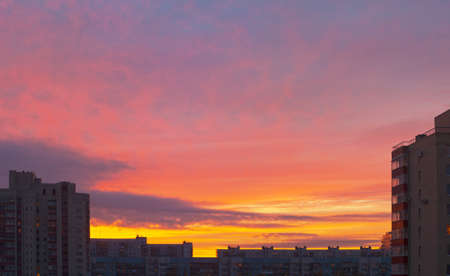 the sunrise sky over roofs of skyscrapers