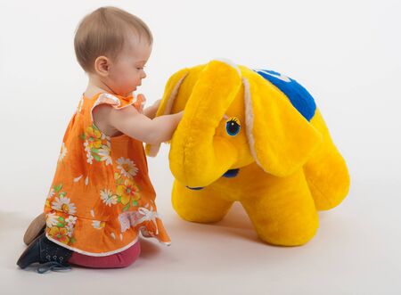 the baby plays with a soft toyの写真素材