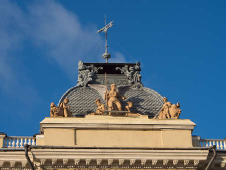 roof of the building with a sculpture and weather vaneの写真素材