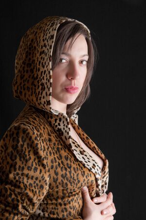 Portrait of a beautiful girl in a leopard suitの写真素材