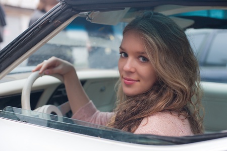 The girl with blue eyes in the white car