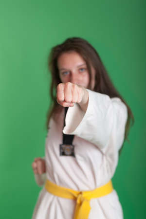 girl in kimono engaged taekwondo, studio shotの写真素材
