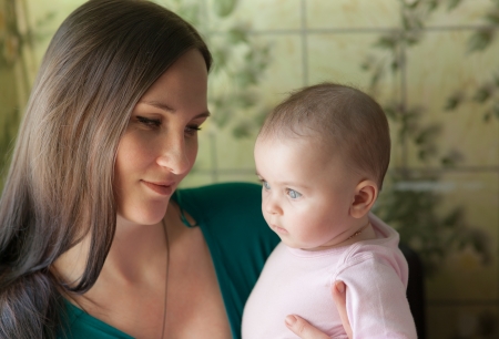portrait of mother with daughter in her armsの写真素材