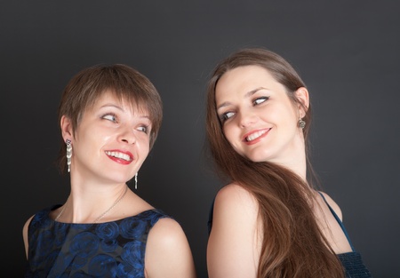 portrait of two cheerful girls on a black backgroundの写真素材