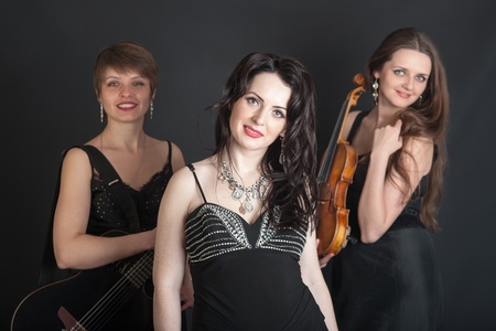 Musical trio portrait on a black backgroundの写真素材