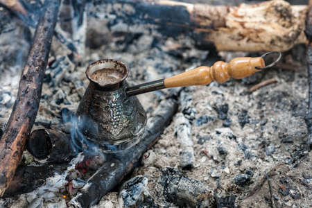 making coffee in cezve on coal fireの写真素材
