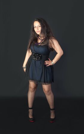 Studio portrait of a girl in a dark dressの写真素材