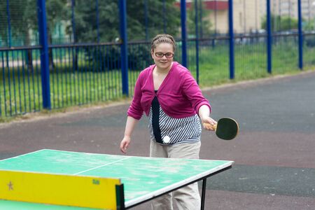 girl plays table tennis in the yardの写真素材