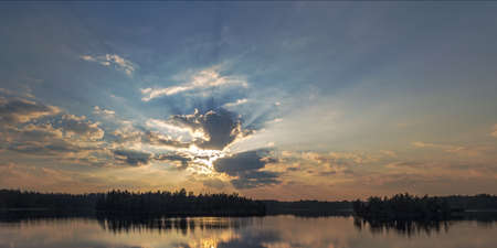 evening with the sun behind the cloudsの写真素材