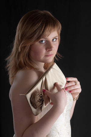 elegant girl in a white dress with a handbagの写真素材