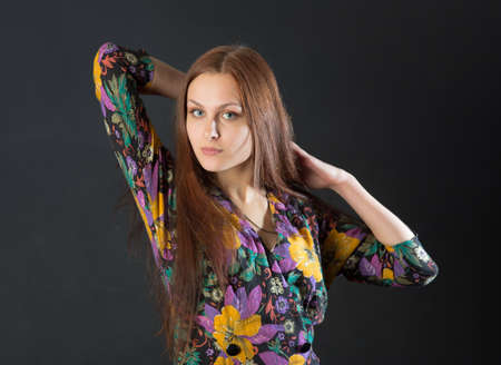 girl in a bright dress on a black backgroundの写真素材