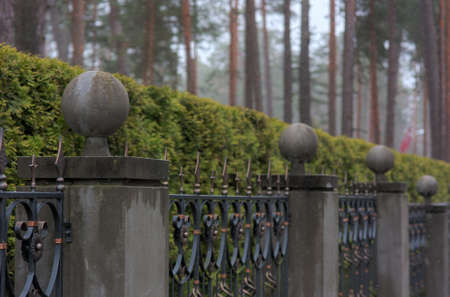 iron fence with stone pillars and ballsの写真素材