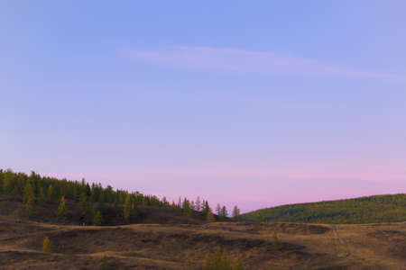 turns pink sky at dawn in the mountainsの写真素材